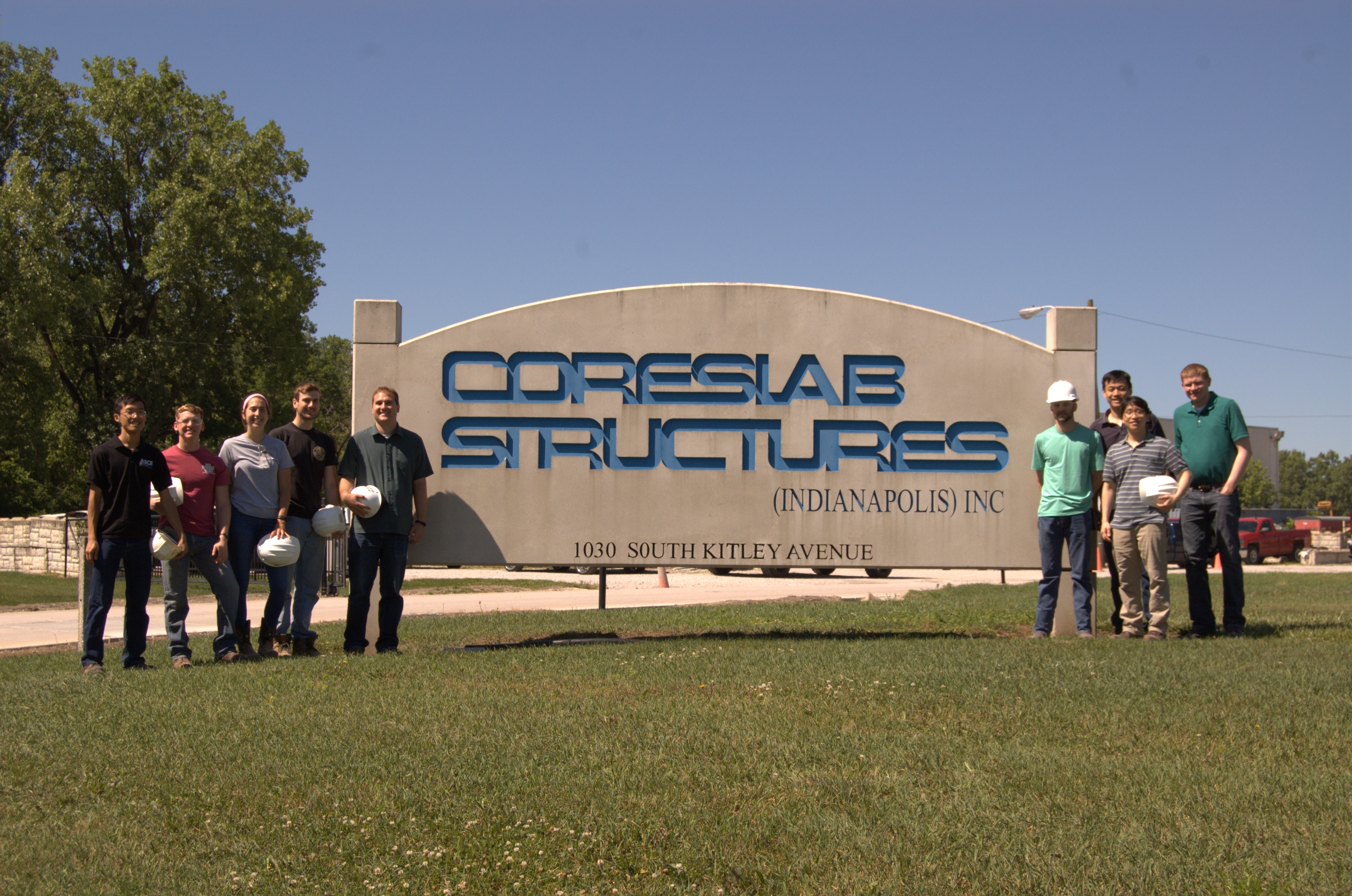 Group Photo in front of the Coreslab sign